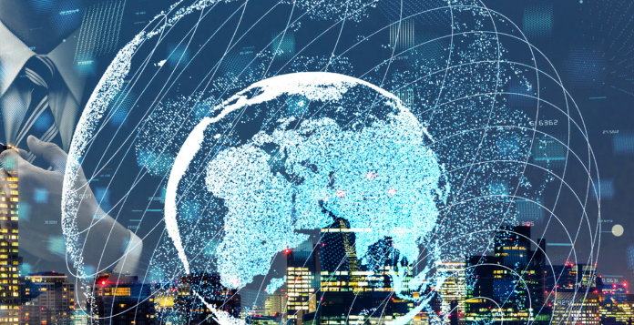 City skyline with illuminated world globe in the front